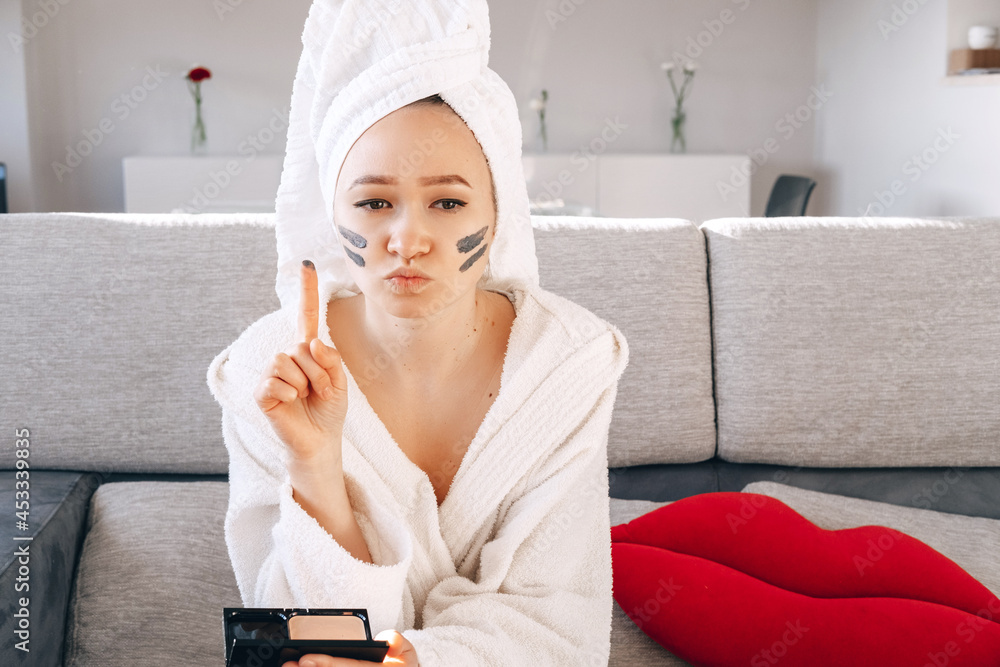Asian Female Applying Clay Black Facial Purifying Peeling Mask or Scrub. Home Spa and Wellness. Skincare Products. Taking Care of yourself. Asian Female Applying Clay Black Facial Purifying Peeling Mask or Scrub. Home Spa and Wellness. Skincare Products. Taking Care of yourself.