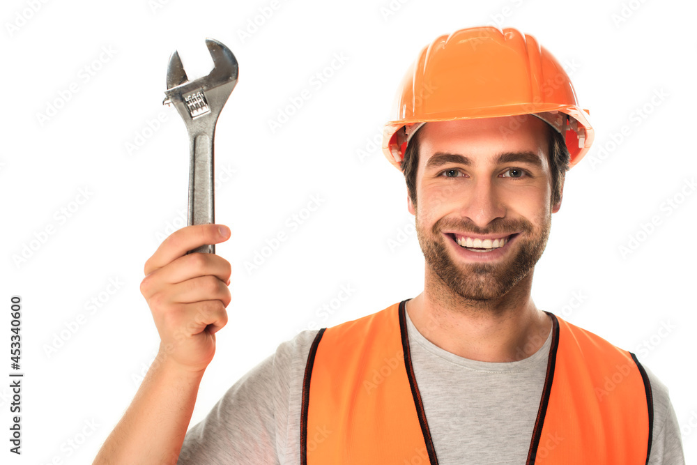 Positive builder in hard hat holding wrench isolated on white Positive builder in hard hat holding wrench isolated on white