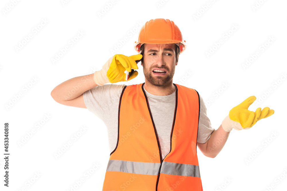 Confused builder talking on smartphone isolated on white Confused builder talking on smartphone isolated on white