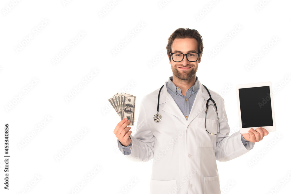 Smiling doctor holding digital tablet and money isolated on white Smiling doctor holding digital tablet and money isolated on white