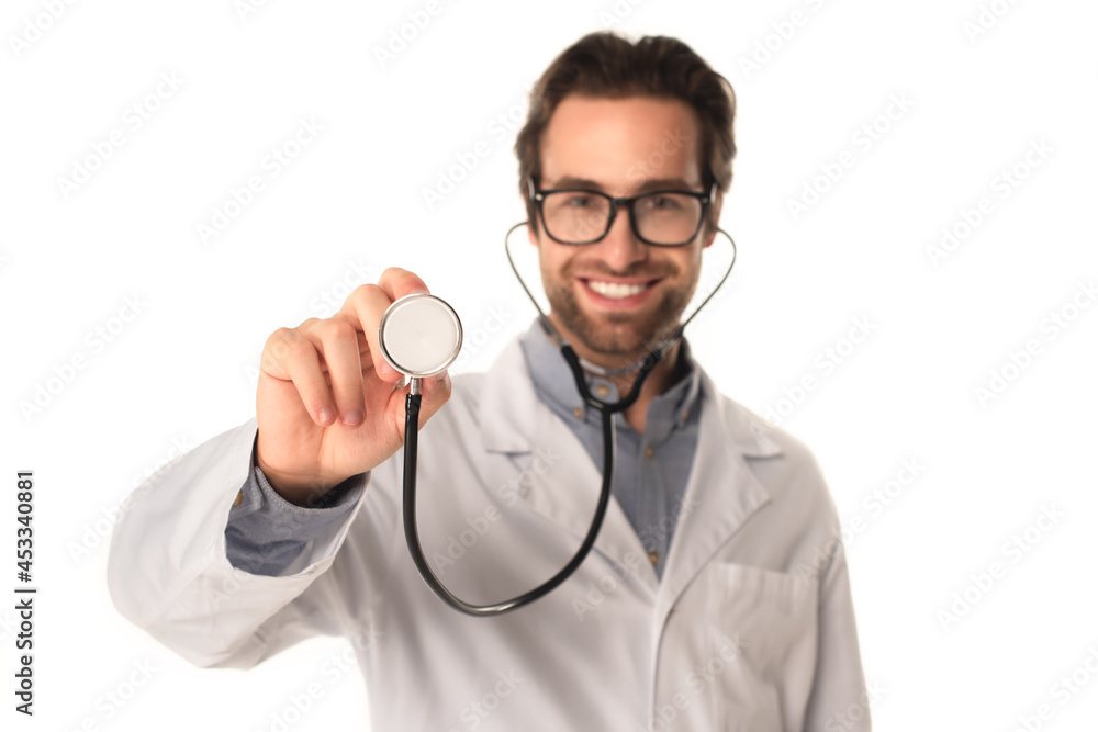 Blurred doctor holding stethoscope isolated on white Blurred doctor holding stethoscope isolated on white