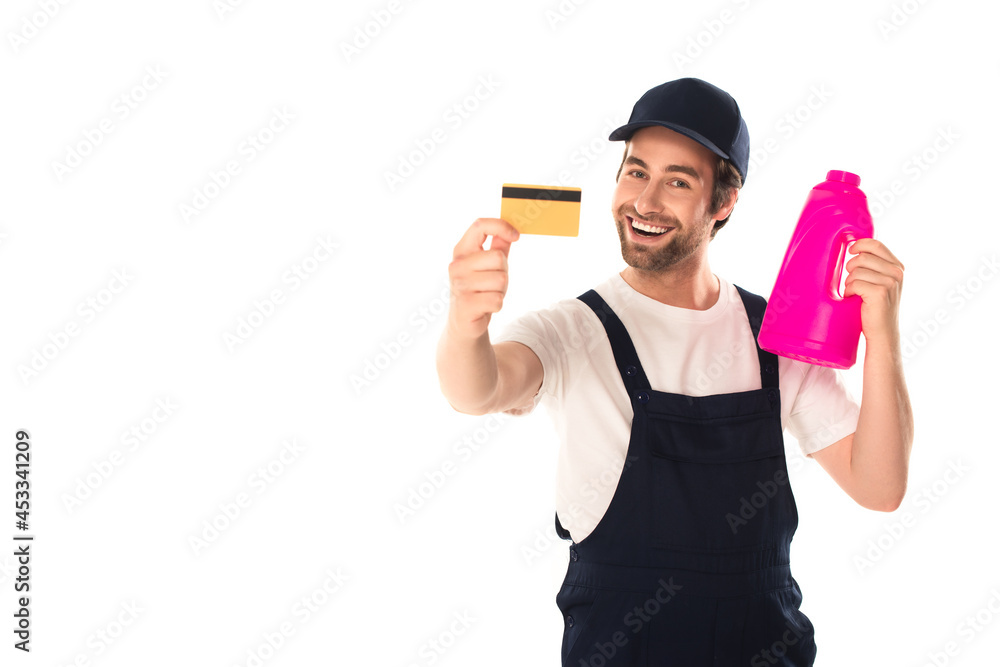 Smiling cleaner holding detergent and credit card isolated on white Smiling cleaner holding detergent and credit card isolated on white