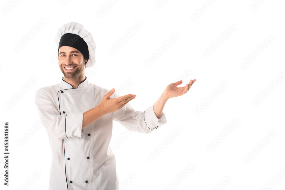 Cheerful chef pointing with hands isolated on white Cheerful chef pointing with hands isolated on white