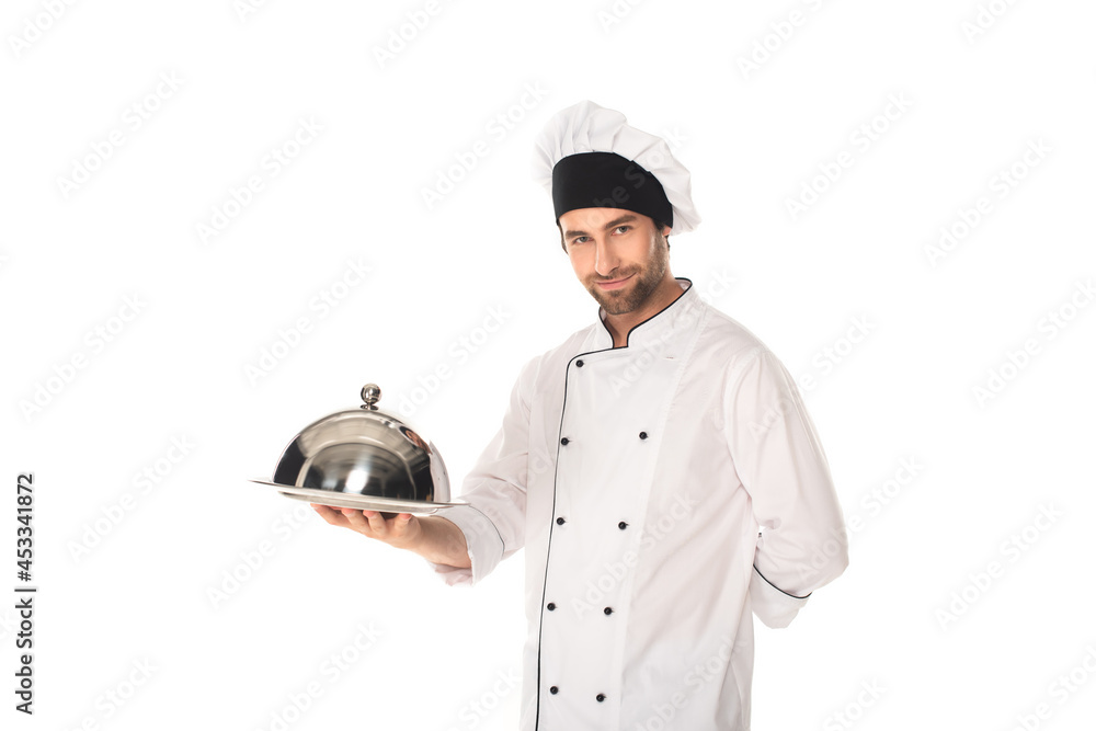 Chef in uniform holding cloche and tray isolated on white Chef in uniform holding cloche and tray isolated on white