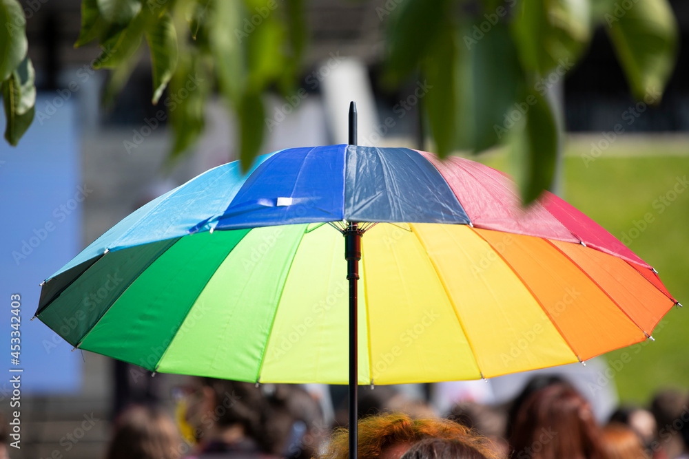 Rainbow flag umbrella at pride parade. Lgbtq concept