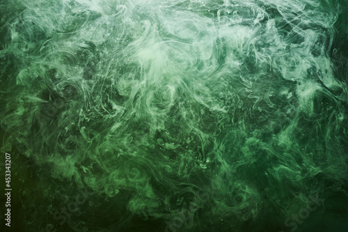 Abstract green color background. Swirling vibrant hookah smoke, underwater emerald ocean, dynamic paint in water