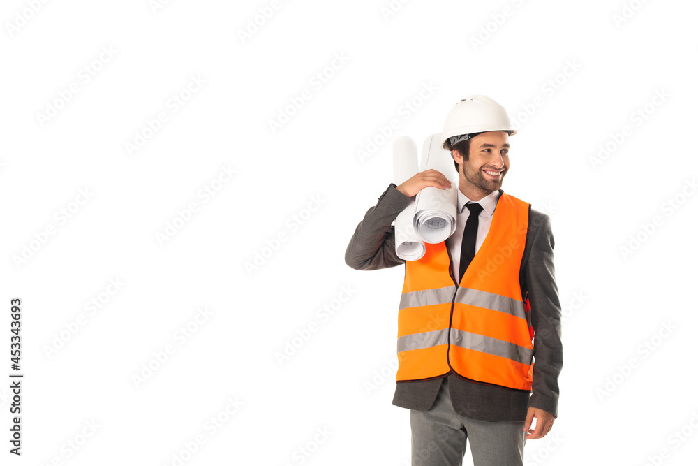 Smiling engineer in formal wear and hard hat holding blueprints isolated on white Smiling engineer in formal wear and hard hat holding blueprints isolated on white
