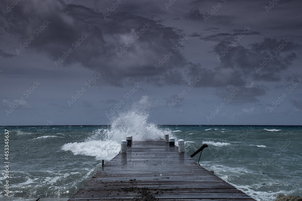 Waves from tropical storm Ida as it blows through the Cayman Islands pummel the dock in West Bay