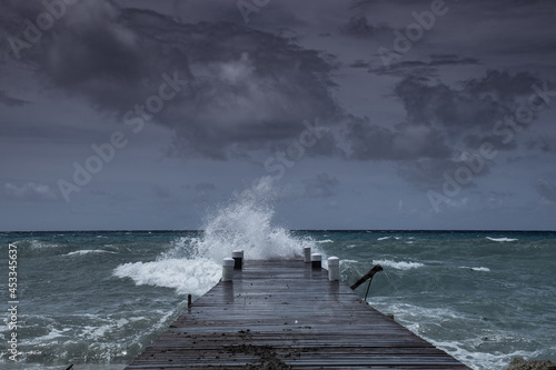 Waves from tropical storm Ida as it blows through the Cayman Islands pummel the dock in West Bay photo