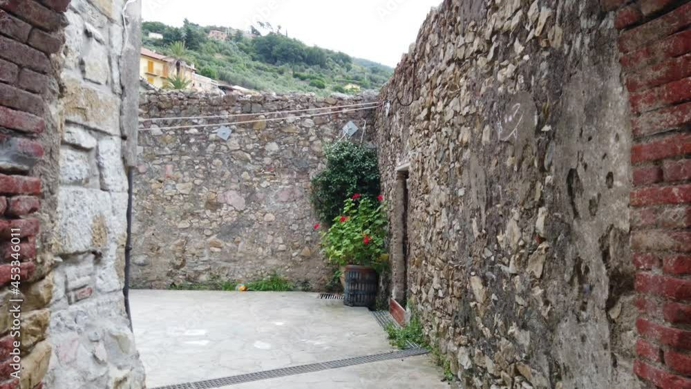 Europe, Italy, Liguria, Framura - walking through an arch leads to a small village with stone buildings and houses - Cadusin Europe, Italy, Liguria, Framura - walking through an arch leads to a small village with stone buildings and houses - Cadusin