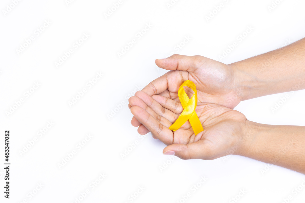 two hands holding yellow ribbon, childhood cancer, white background two hands holding yellow ribbon, childhood cancer, white background
