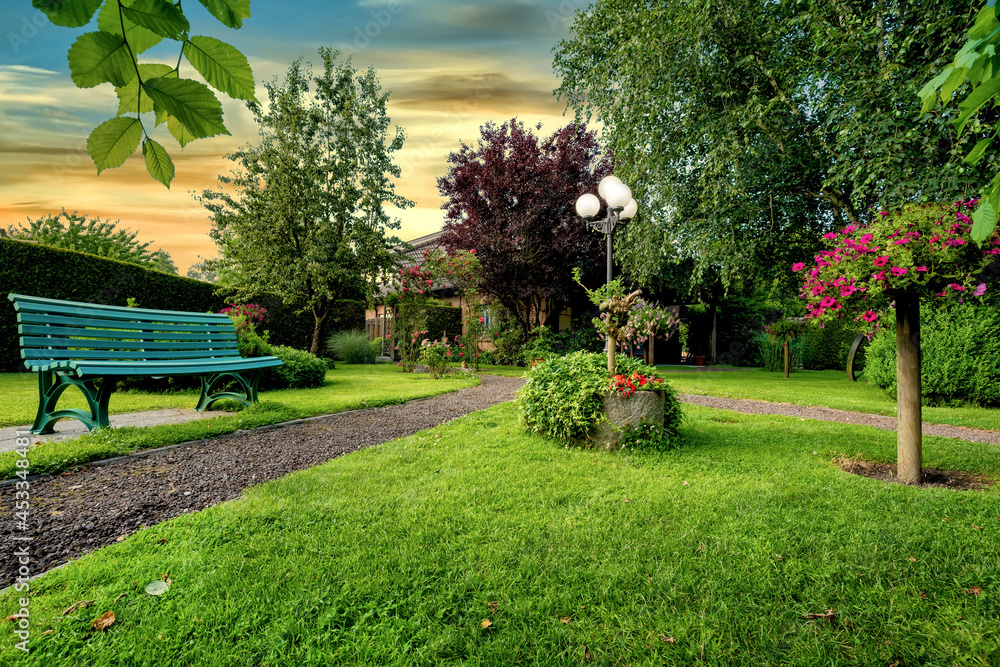 Dreamlike garden design with grass, paths, flowers and other plants - obrazy, fototapety, plakaty 