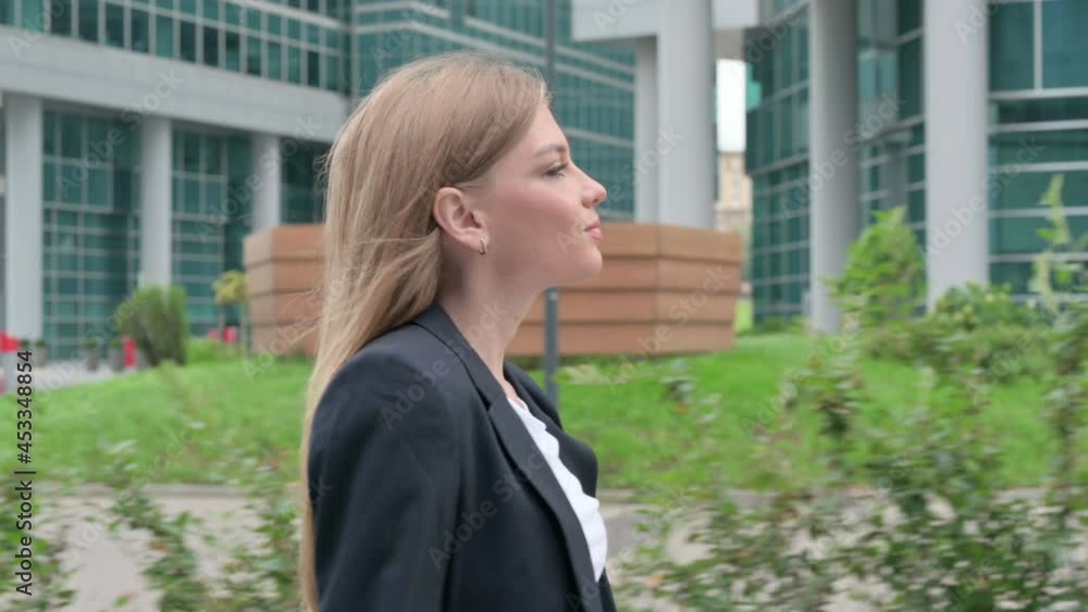 Close up of Young Businesswoman Walking on the Street, Side Pose Close up of Young Businesswoman Walking on the Street, Side Pose