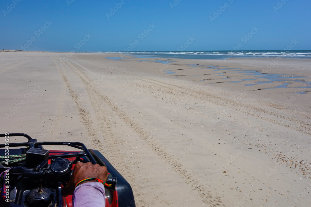 driver POV of ATV quadricycle on the beach in the Brazilian coast, sunny day