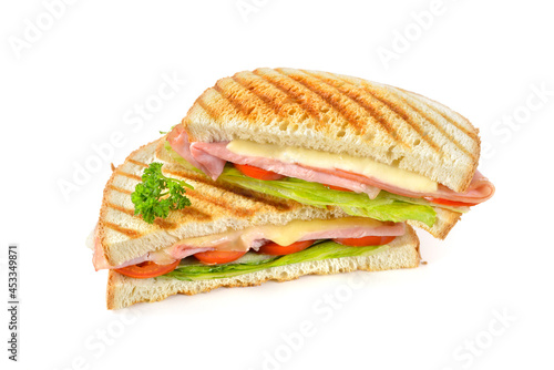 Leckeres Sandwich aus der Paninipresse mit Schinken, Käse und Salat auf weißem Untergrund - Pressed and toasted sandwich with ham, cheese and salad on white background photo