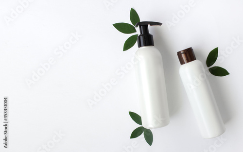Mockup of white empty cosmetic bottles on white background.Copy space, Top View.