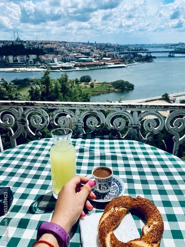 Girl's hand and city view, breakfast