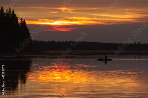 A Lone Boater at the Lake with Setting Sun