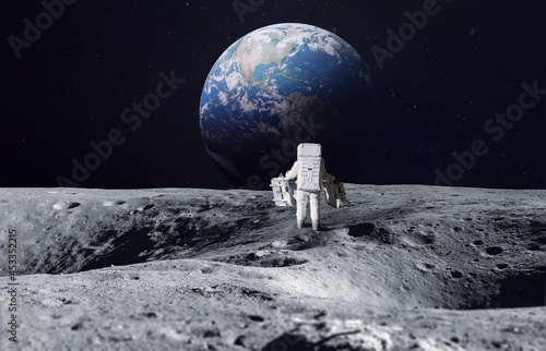 Astronaut on surface of Moon. Planet Earth on the background. Apollo space program. Artemis program. Elements of this image furnished by NASA.
