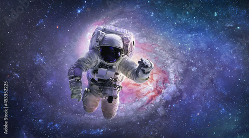 Astronaut in bright outer space. Galaxy and nebula. Galactic sci-fi wallpaper. Spaceman. Elements of this image furnished by NASA