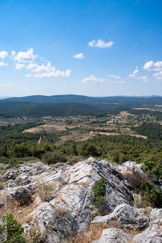 Mountain meadow in  countryside under cloudy blue sky