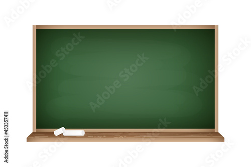 Realistic blackboard with empty green space. Chalkboard with wooden frame and pieces of chalk. Education supplies concept.