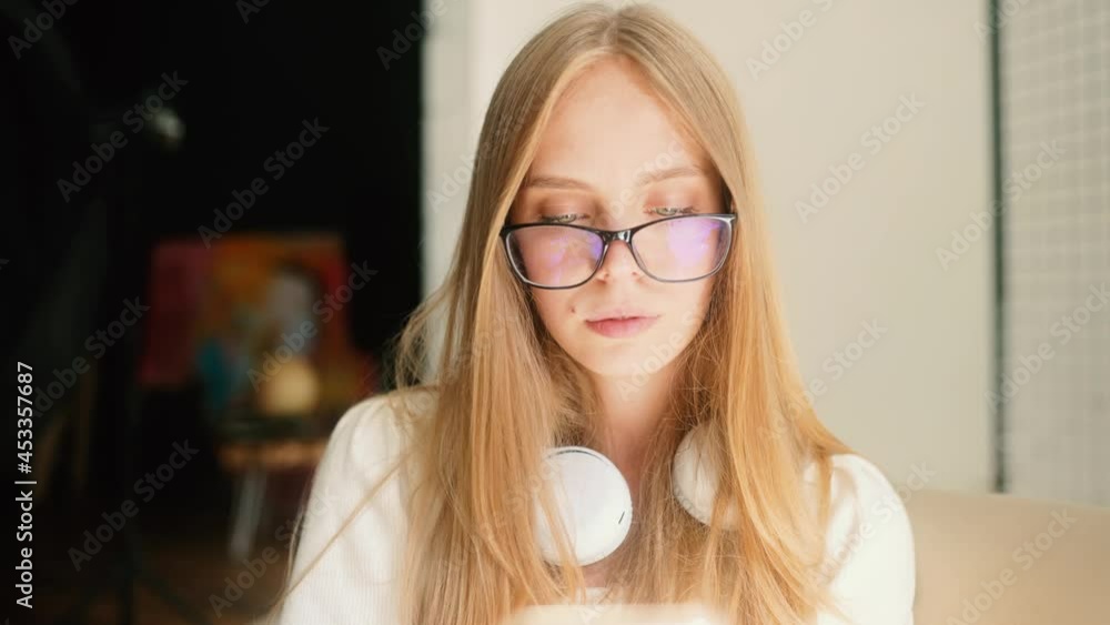 Beautiful girl using smart phone. Close up of attractive young woman texting on smartphone in her flat. High quality 4k footage Beautiful girl using smart phone. Close up of attractive young woman texting on smartphone in her flat. High quality 4k footage