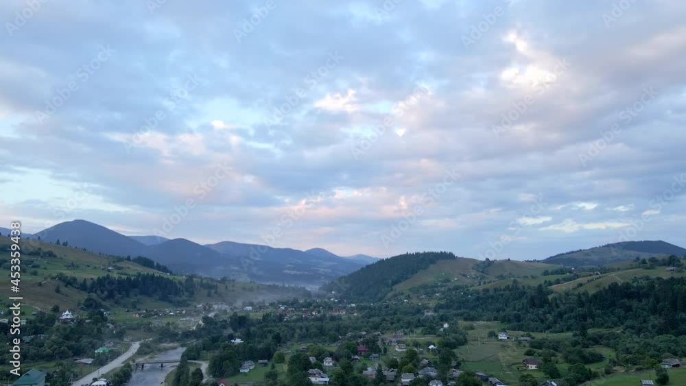 aerial view of carpathian mountains with small village on sunset aerial view of carpathian mountains with small village on sunset