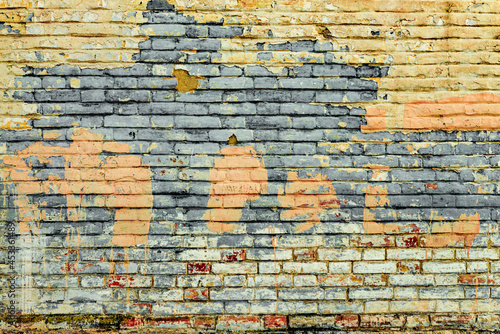 Texture of a brick wall with cracks and scratches which can be used as a background