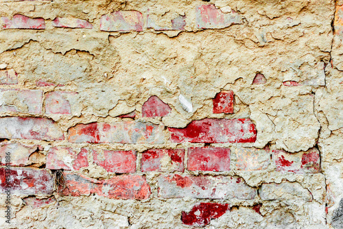 Texture of a brick wall with cracks and scratches which can be used as a background