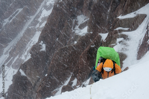 A climber during a storm in the mountains photo