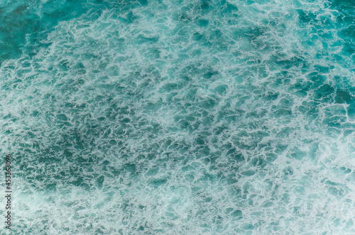 Detail of the ocean with waves and white bubbles