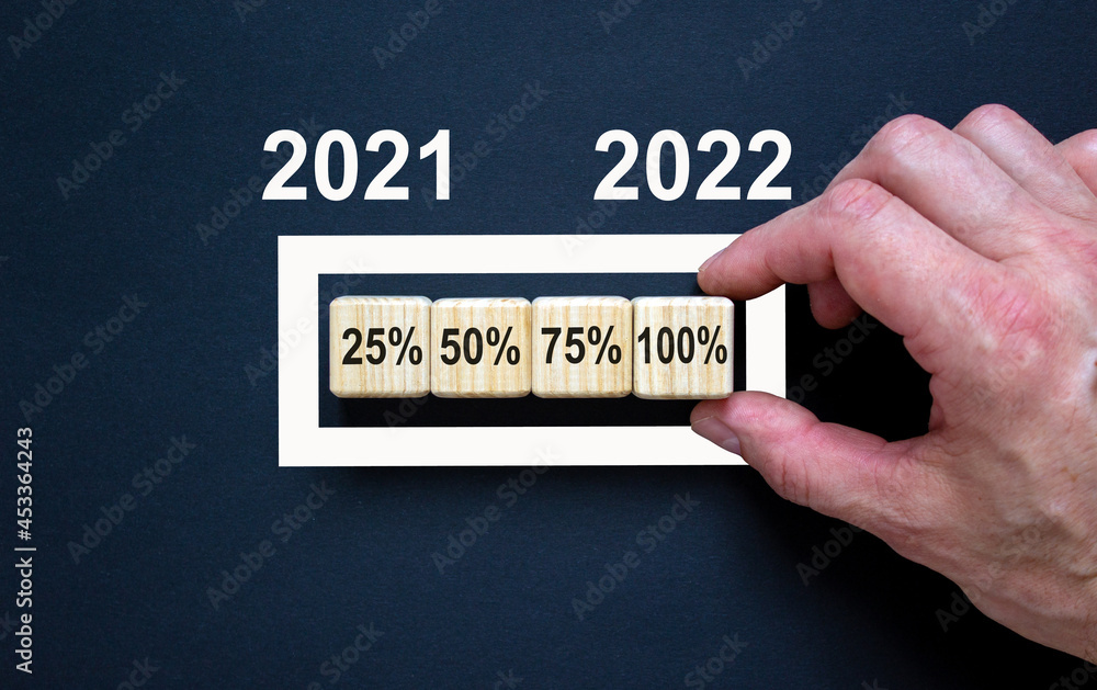 2022 happy new year symbol. Wooden cubes symbolize the change to the new year 2022. Businessman hand, numbers 2021, 2022. Beautiful black background. Copy space. Business, 2022 happy new year concept. 2022 happy new year symbol. Wooden cubes symbolize the change to the new year 2022. Businessman hand, numbers 2021, 2022. Beautiful black background. Copy space. Business, 2022 happy new year concept.