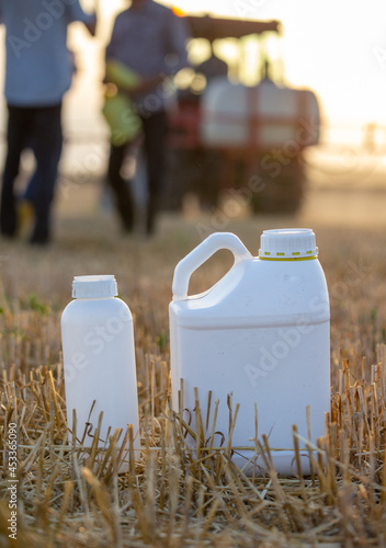 Plastic containers with pesticides in field