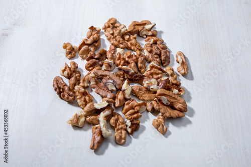 walnut halves on white wooden background