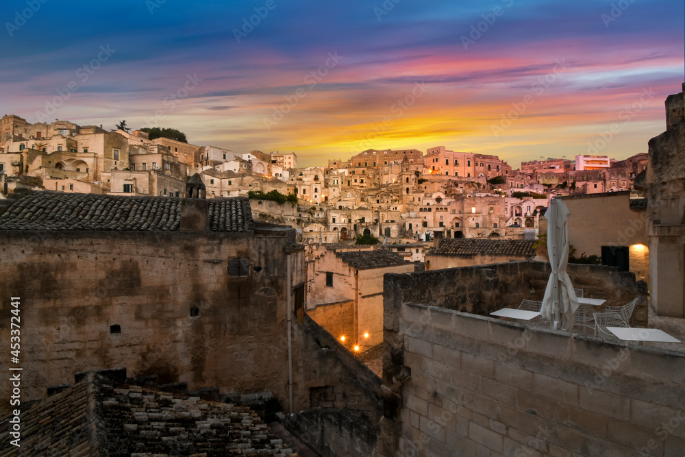 A colorful sunset over the ancient sassi and dwellings in the town of Matera, Italy, in the Basilicata region.