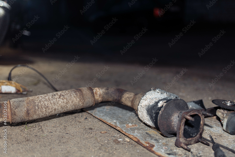 Removing the catalytic converter from the muffler of the vehicle, the