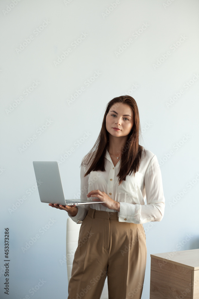 young beautiful girl in office clothes works on a laptop young beautiful girl in office clothes works on a laptop
