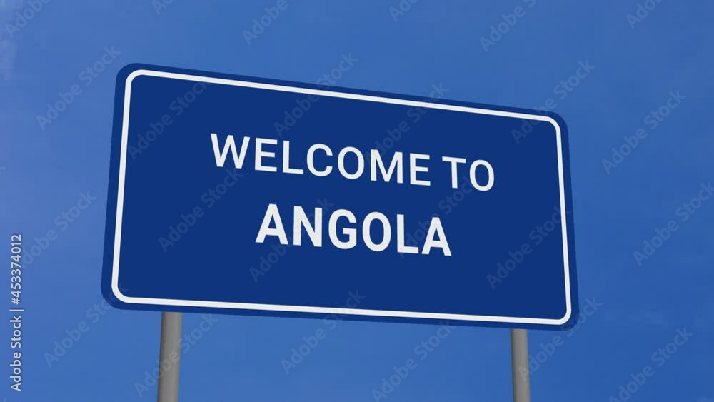 Welcome to Angola Road Sign on Clear Blue Sky with Rapid Moving Clouds Welcome to Angola Road Sign on Clear Blue Sky with Rapid Moving Clouds