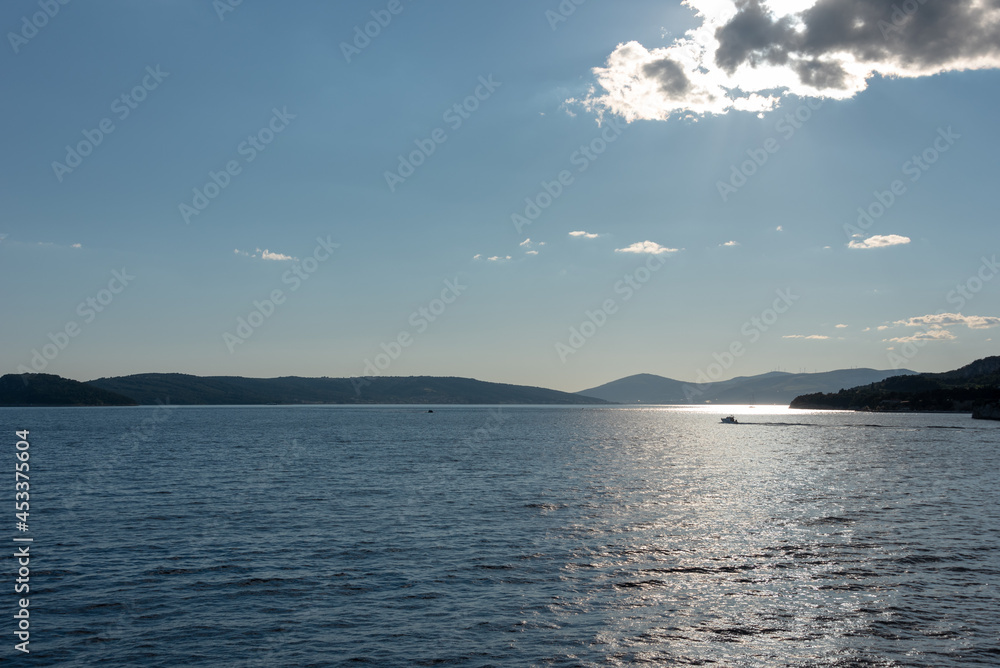 Shore of Adriatic Sea in Croatia under cloudy sky. Islands in the background. Shore of Adriatic Sea in Croatia under cloudy sky. Islands in the background.