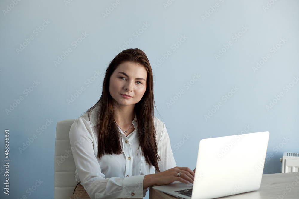 young beautiful girl in office clothes works on a laptop young beautiful girl in office clothes works on a laptop