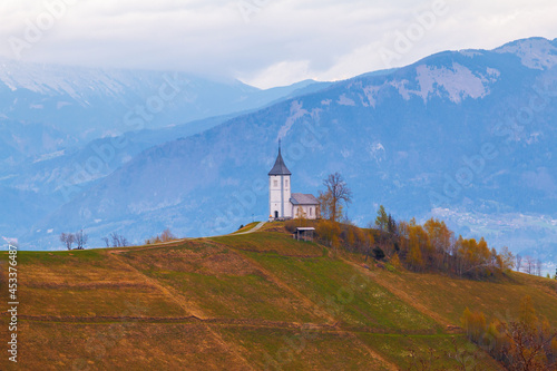 On the hilltop the magnificent Church of St. Primus and St. Felician with beautiful views of the landscape, Jamnik village, Kranj village at sunrise, Triglav National Park