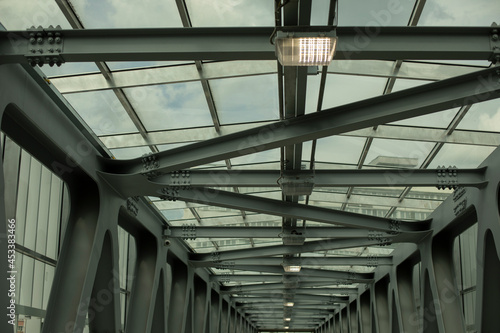 The ceiling of the tunnel is made of iron beams. Modern architecture of the overhead passage. Metal construction. © Олег Копьёв