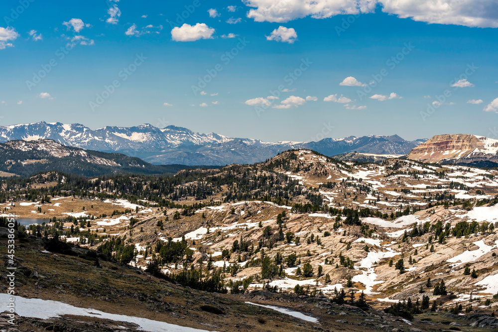 Aerial view of Mountains in Wyoming near Yellowstone National Park. Rocks partially cover with snow on the border of Montana and Wyoming Aerial view of Mountains in Wyoming near Yellowstone National Park. Rocks partially cover with snow on the border of Montana and Wyoming