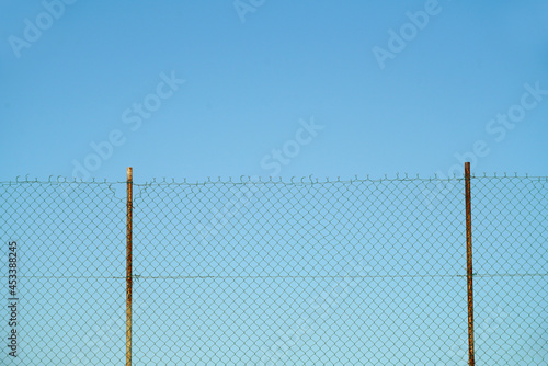 close up on iron chainlink fence against sky