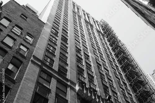 black and white building shot from below with fire escape