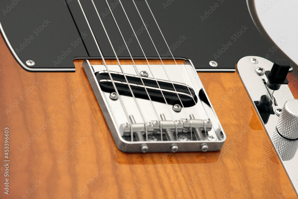 Electric guitar bridge, strings, pickups, pickguard, selector, volume and tone controls Electric guitar bridge, strings, pickups, pickguard, selector, volume and tone controls