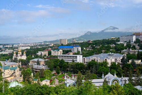 View of the Caucasus Mountains around the city of Pyatigorsk, Russia, with a park, a church, sanatoriums and residential buildings
