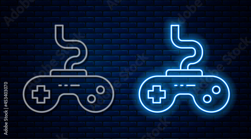 Glowing neon line Gamepad icon isolated on brick wall background. Game controller. Vector