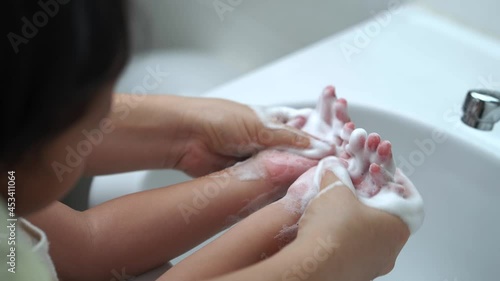 Wallpaper Mural Mother washing her daughter's  hands to prevent virus and germs and bacteria at Wash Basin Sink. Torontodigital.ca